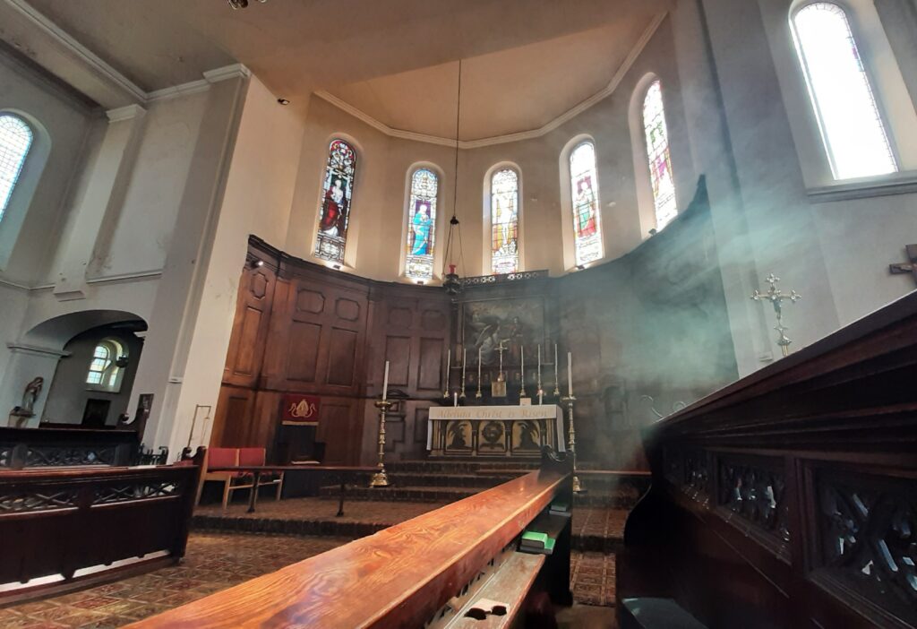 A waft of incense smoke floats eeriliy to the left of the high altar