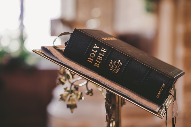 A black bible sits on a lectern